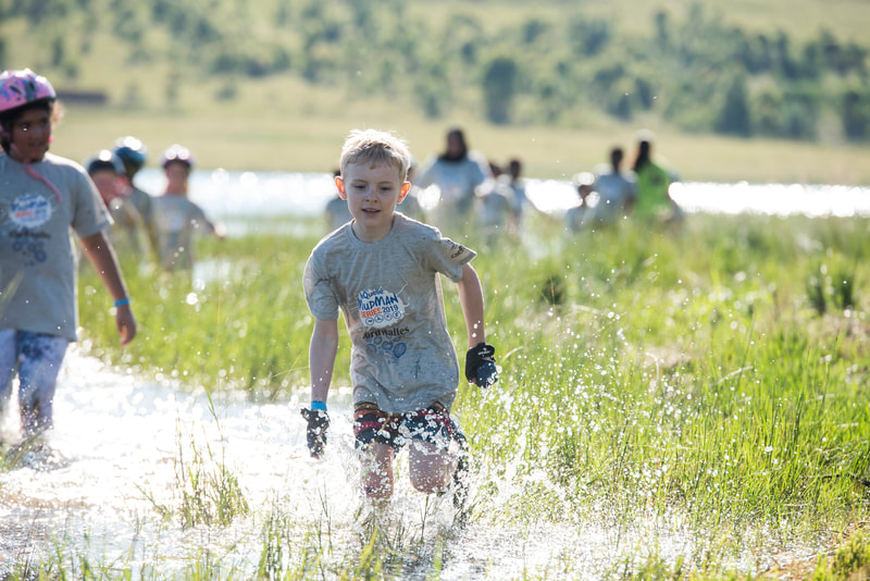 The mud skippers having lots of fun in the bubbles, water and on the bike during the Cordwalles Mudman at Midmar Dam