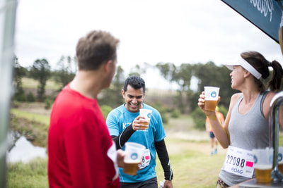 Santosh Bugwandin sharing a joke over a beer with some fellow trail runners - (c) Andrew Mc Fadden / BOOGS Photography