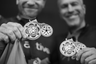 Two very proud athletes showing off the 2018 ABSA Cape Epic medals