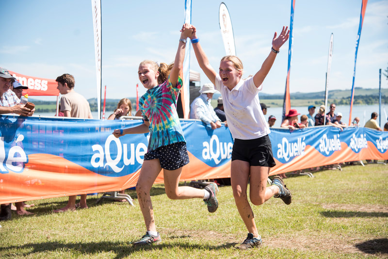 Teams finishing the Cordwalles Mudman at Midmar Dam in high spirits and huge smiles on their faces